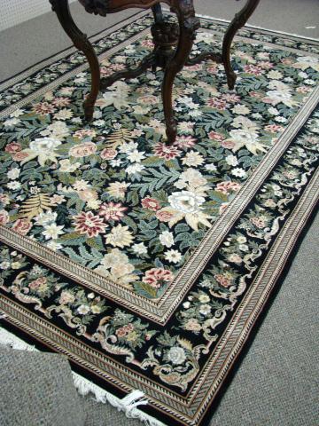 Appraisal: Pakistani Basberbian x rug black background with floral decor circa