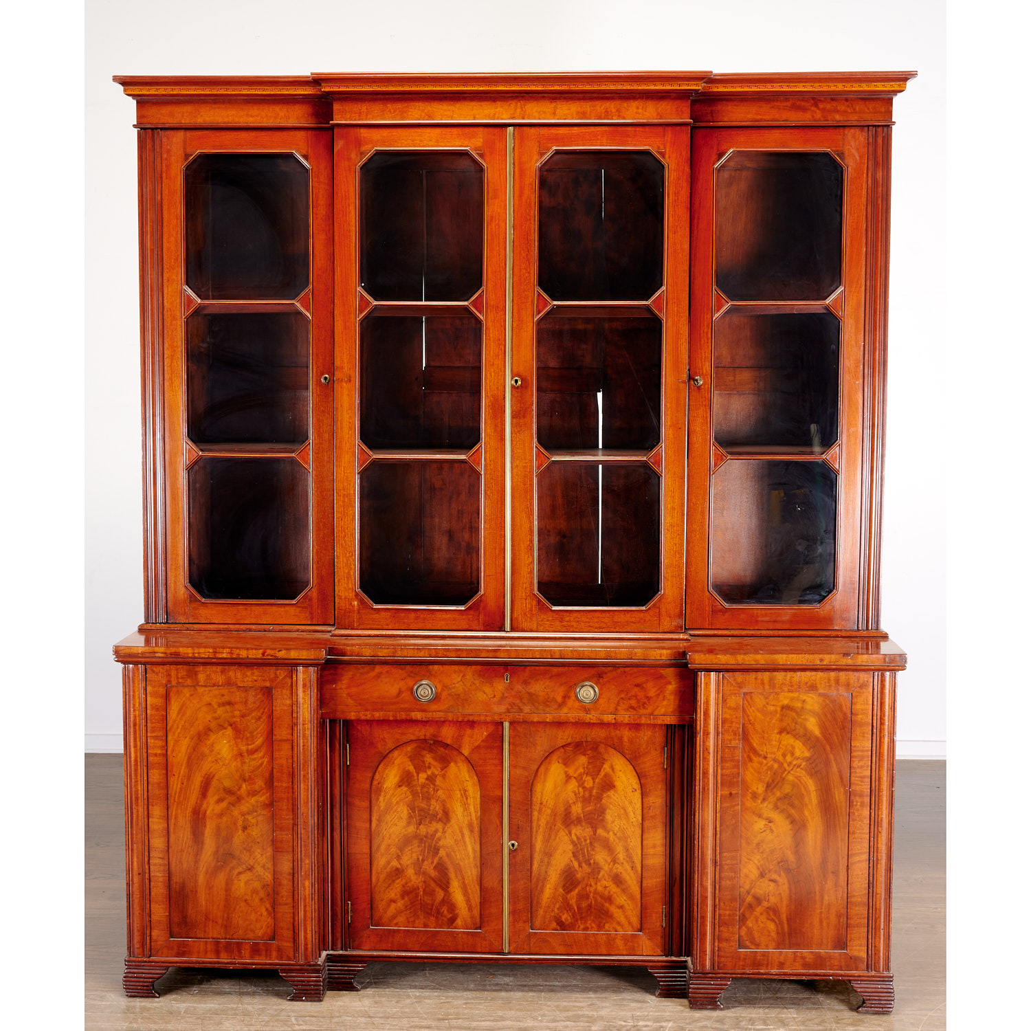 Appraisal: UNUSUAL LATE REGENCY MAHOGANY BREAKFRONT BOOKCASE th c England the