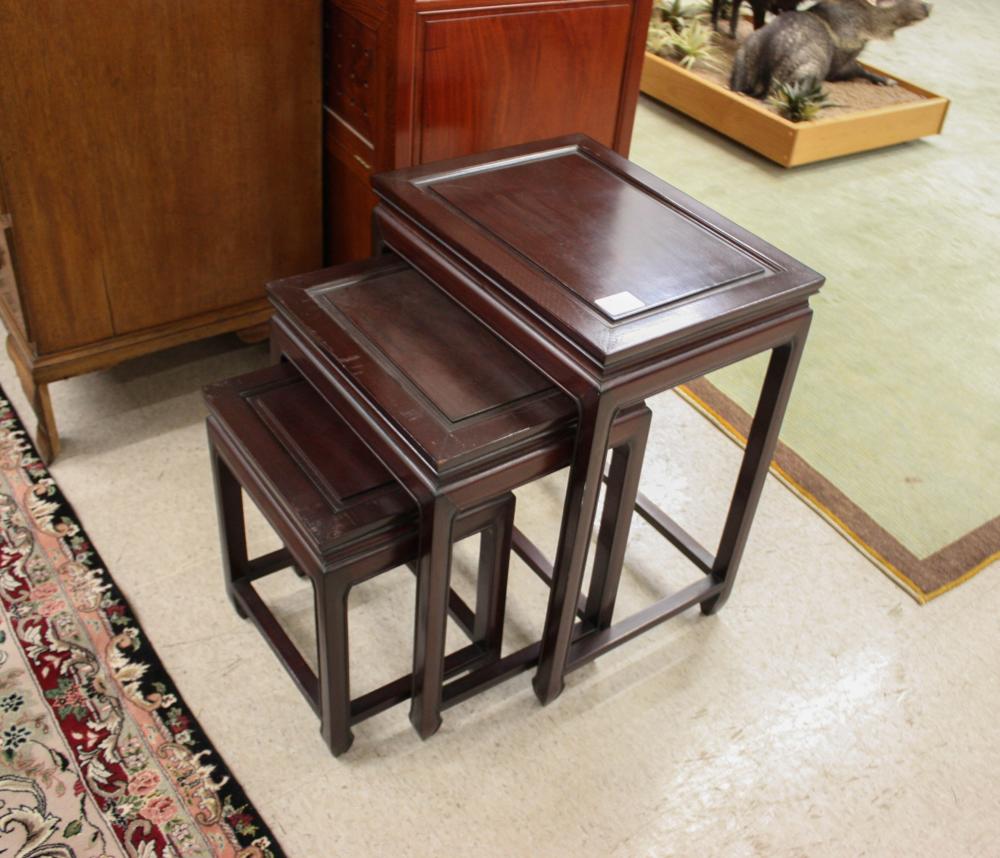 Appraisal: A SET OF THREE CHINESE DARK TEAKWOOD NESTING TABLES rectangular