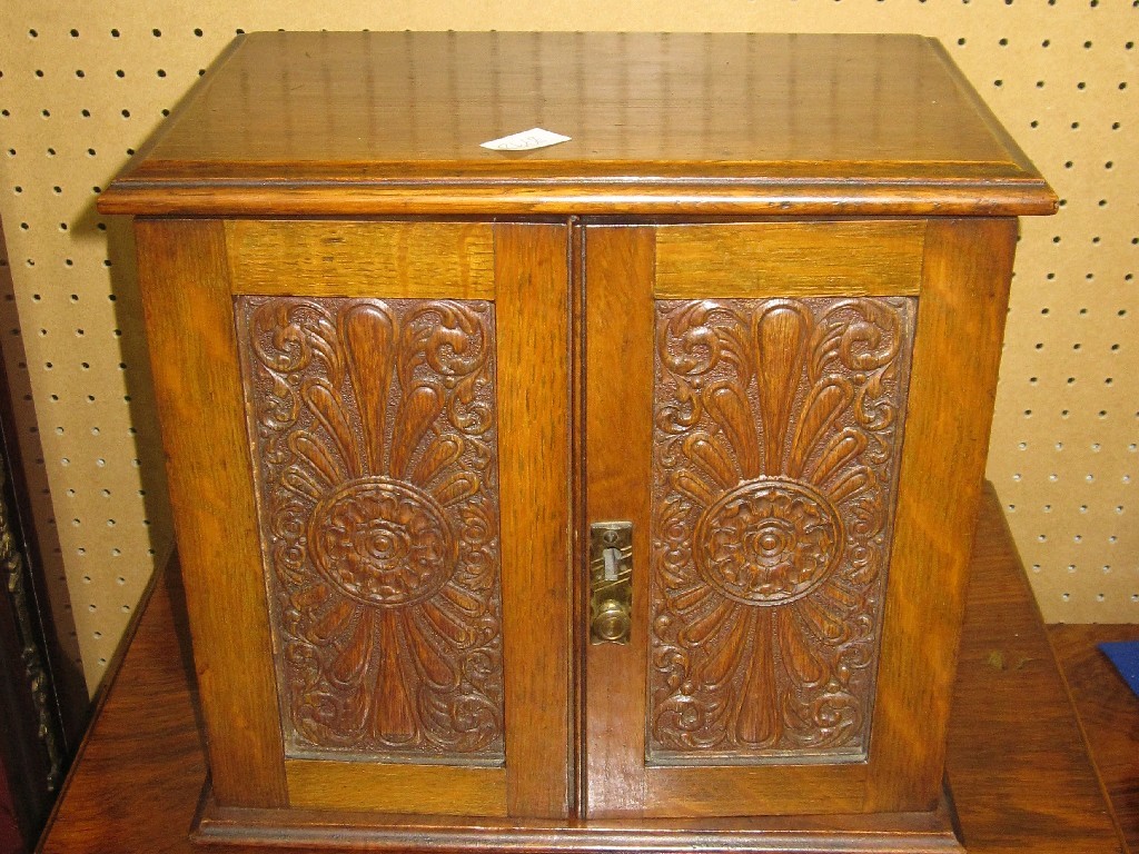 Appraisal: Carved oak two door cabinet