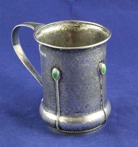 Appraisal: An Edwardian Arts Crafts planished silver and enamelled christening mug