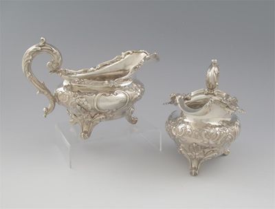 Appraisal: A pair of Victorian embossed sauceboats on three foliate scroll