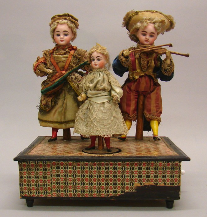 Appraisal: All original Automaton with three German dolls Pair of dolls