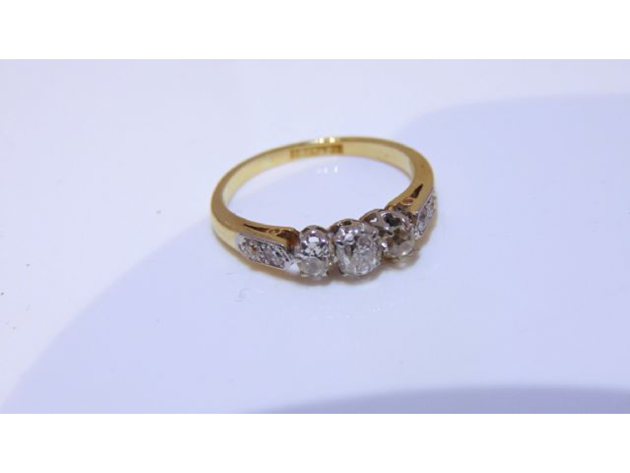 Appraisal: A diamond ring centred with three old-cut diamonds weighing approximately