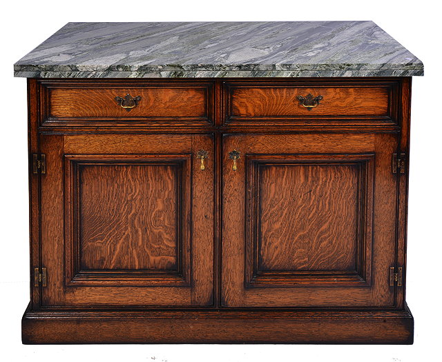 Appraisal: AN OAK MARBLE TOPPED SIDE CABINET with two oak drawers