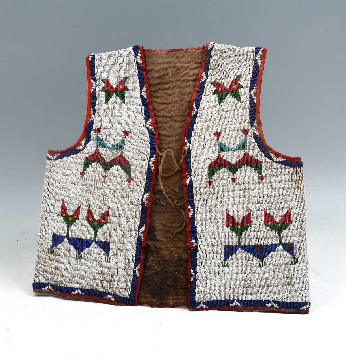 Appraisal: NATIVE AMERICAN INDIAN BEADED BOYS HIDE VEST Hide vest is