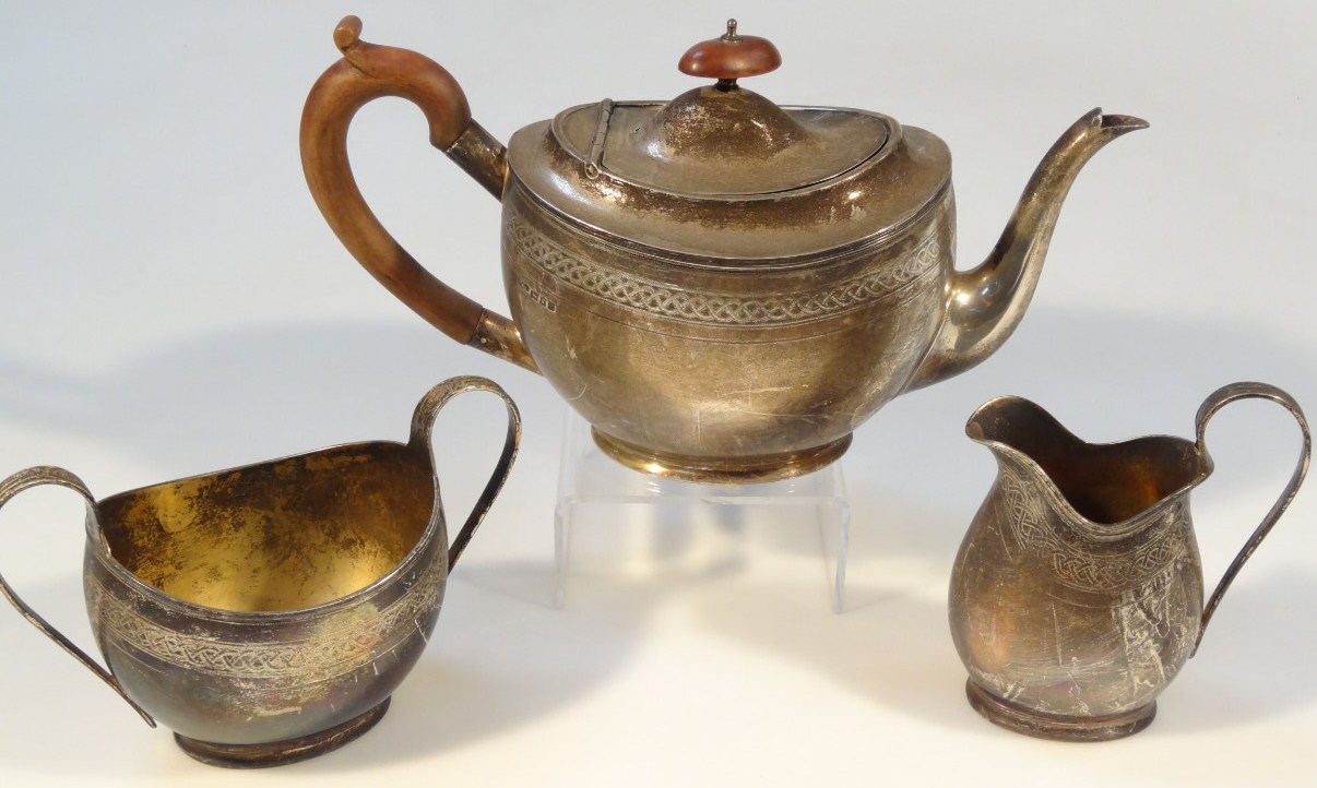 Appraisal: A George V silver three piece tea service comprising teapot