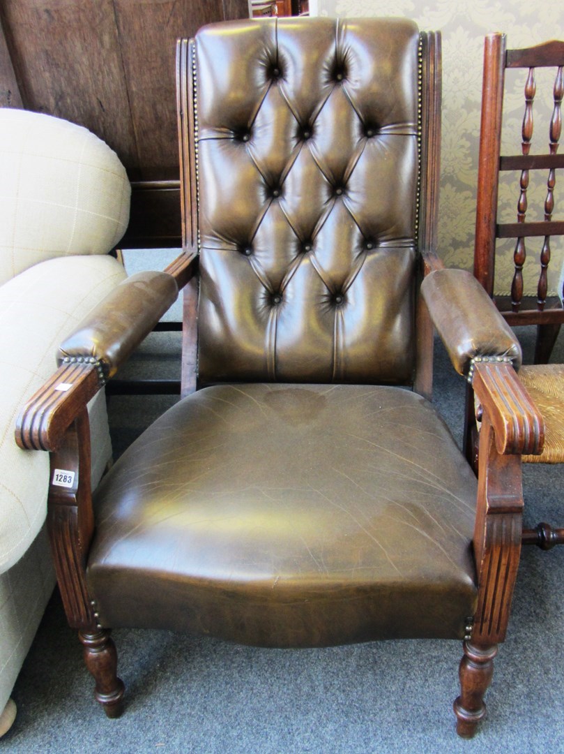 Appraisal: A late th century oak and beech leather upholstered library