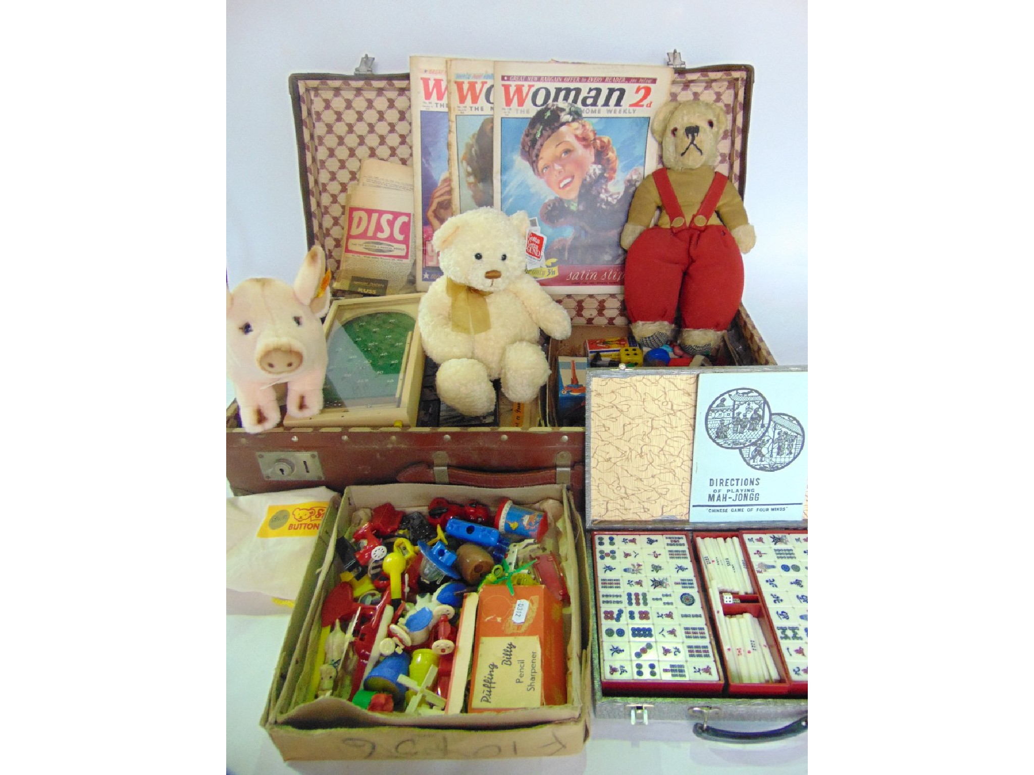 Appraisal: A vintage stitched suitcase containing various toys to include an