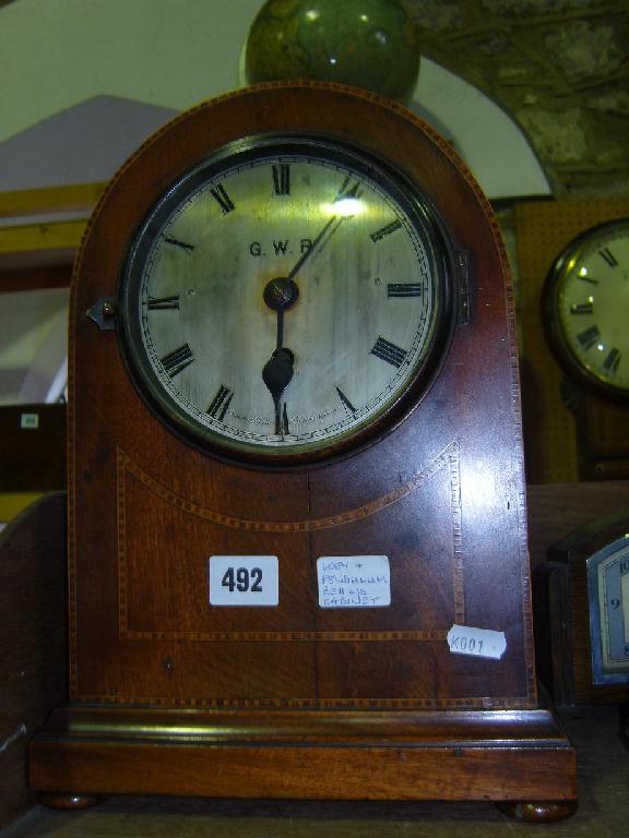 Appraisal: An Edwardian mahogany station master's clock the lancet shaped case