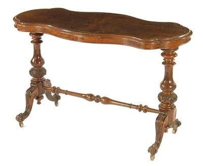 Appraisal: A walnut centre table the shaped top with later burr