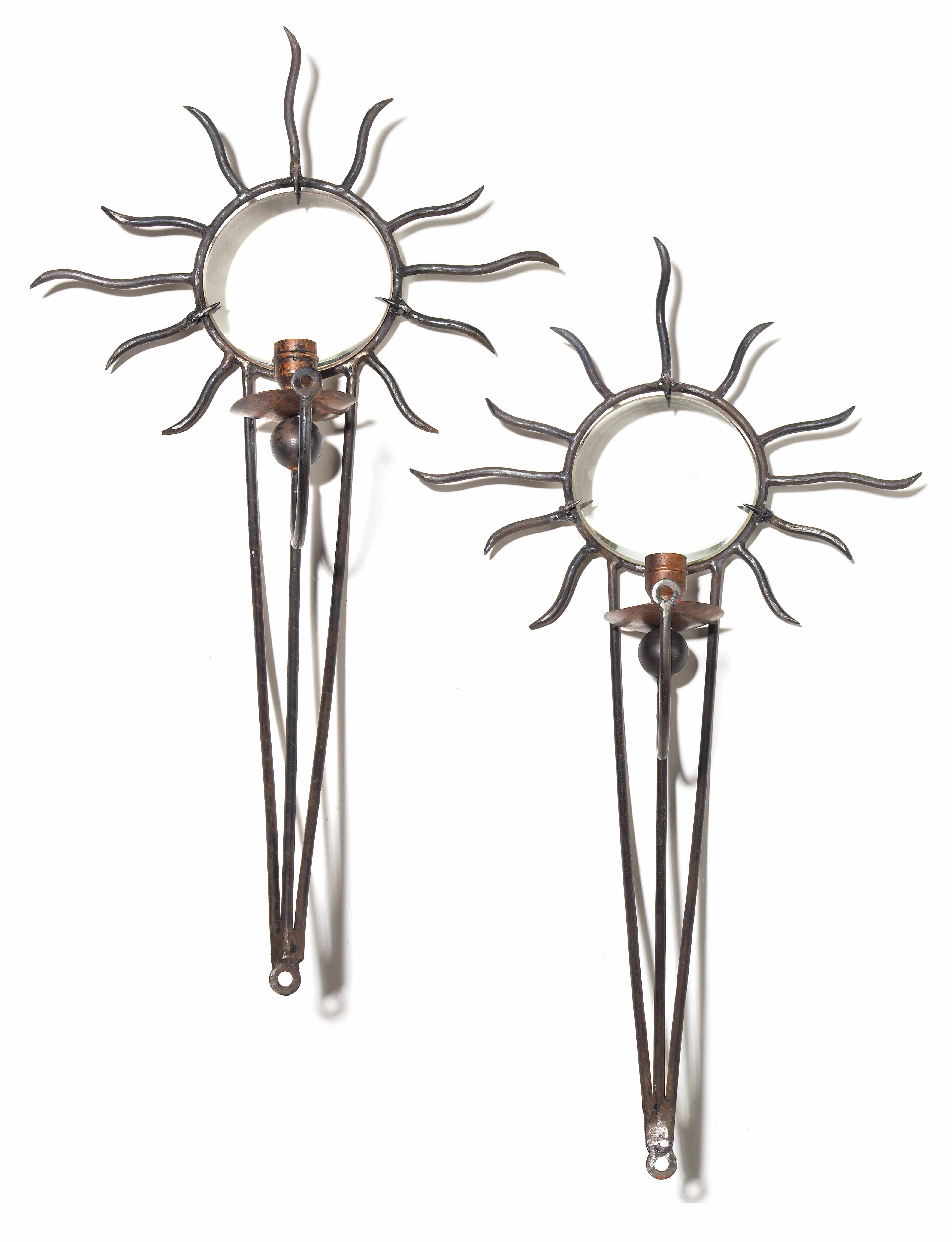 Appraisal: A pair of Andr Dubreuil 'Soleil' patinated wrought iron and