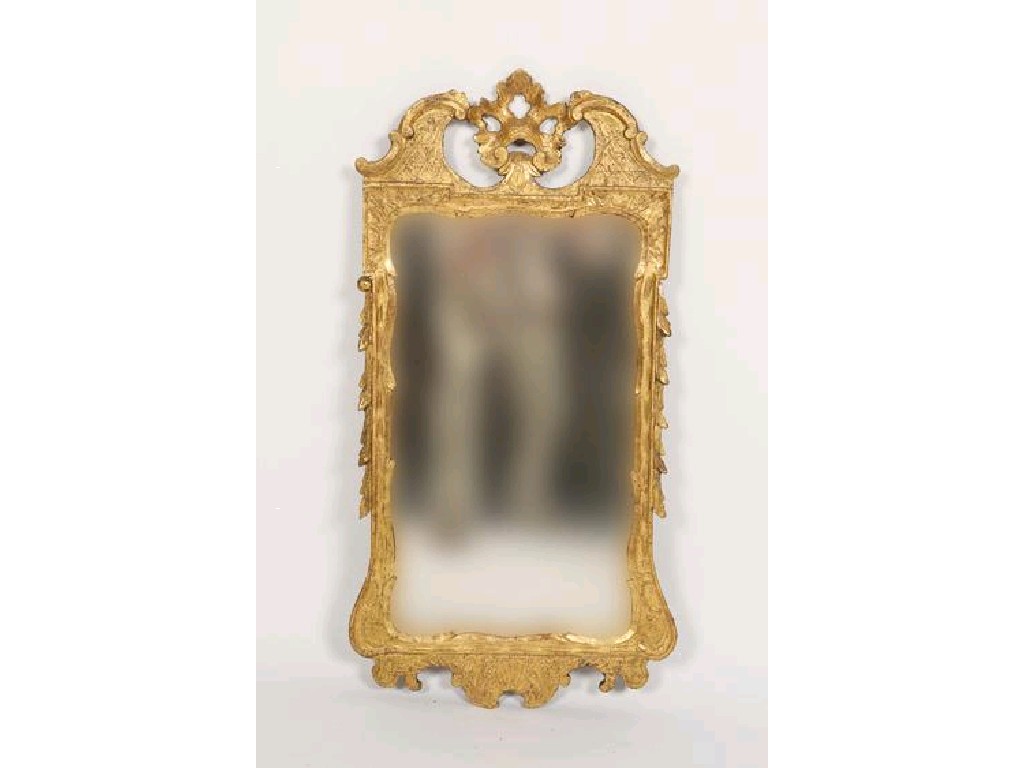 Appraisal: A GEORGE II GILTWOOD WALL MIRROR the rectangular plate within