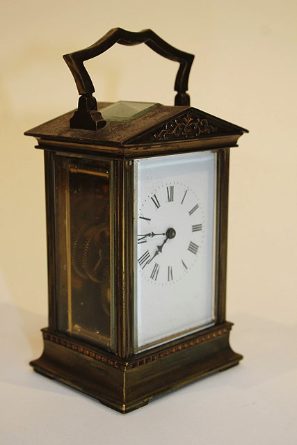 Appraisal: A FRENCH BRASS CARRIAGE TIMEPIECE with architectural case white enamel