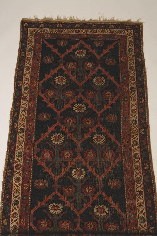 Appraisal: A NORTH WEST PERSIAN TRIBAL RUNNER the dark blue ground