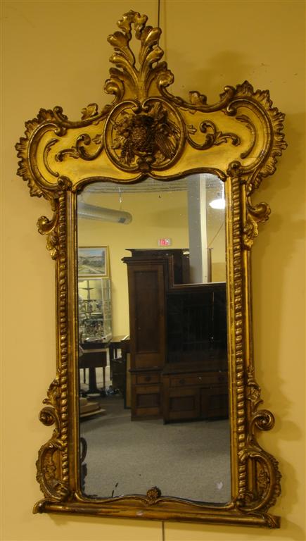 Appraisal: CLASSICAL PINEAPPLE AND CORN HUSK CARVED GILTWOOD MIRROR the anthemion