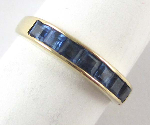 Appraisal: SAPPHIRE AND FOURTEEN KARAT GOLD RING set with seven table-cut