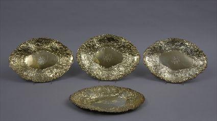 Appraisal: FOUR EARLY GEORGE III SILVER-GILT SMALL PLATTERS WITH LATER MONOGRAMS