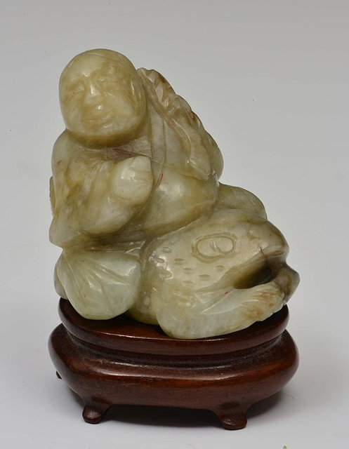 Appraisal: A CHINESE MOTTLED GREEN AND MUTTON FAT JADE PEBBLE carved