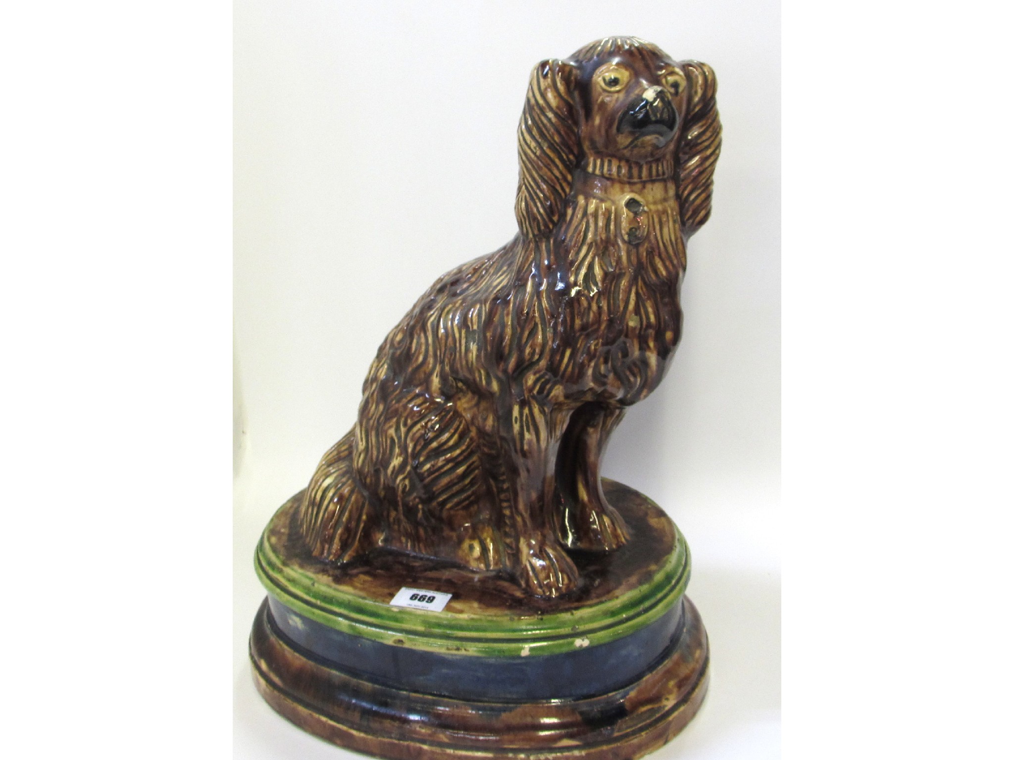 Appraisal: Majolica glazed pottery model of a spaniel upon oval stepped