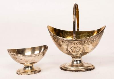 Appraisal: A George III silver and silver gilt swing-handled sugar basket