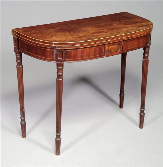 Appraisal: A Regency bowfront mahogany card table circa with baize inset