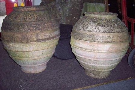 Appraisal: A near pair of terracotta jars of ovoid shape cm