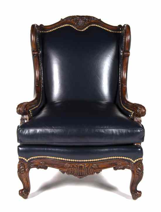 Appraisal: A French Provincial Style Wingback Chair having a carved shell