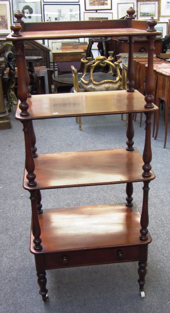 Appraisal: A Victorian mahogany four tier whatnot on turned supports the