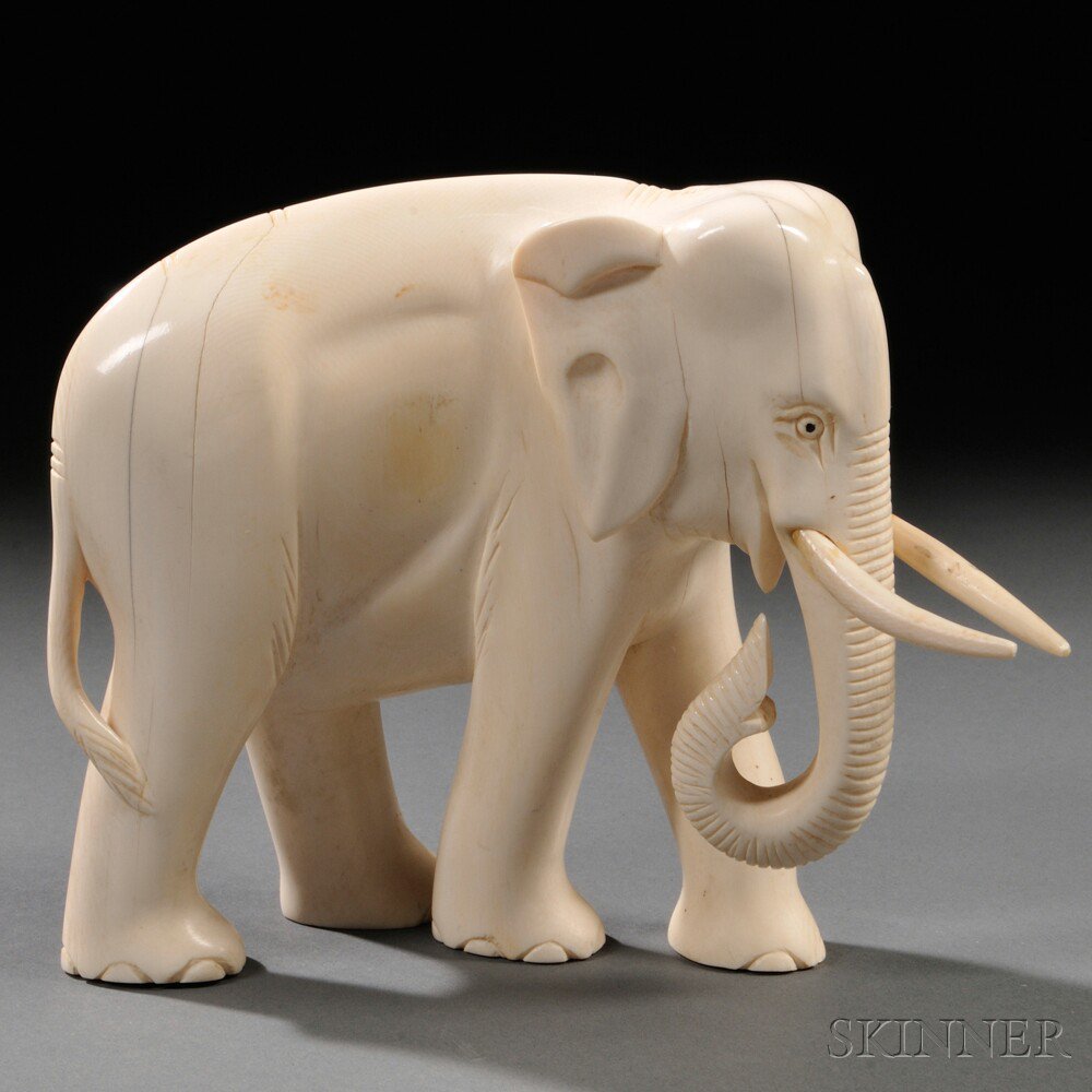 Appraisal: Ivory Elephant China th century walking with its trunk down