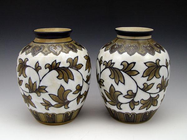 Appraisal: INTRIGUING PAIR OF ART POTTERY VASES Relief glazed effect Unidentified