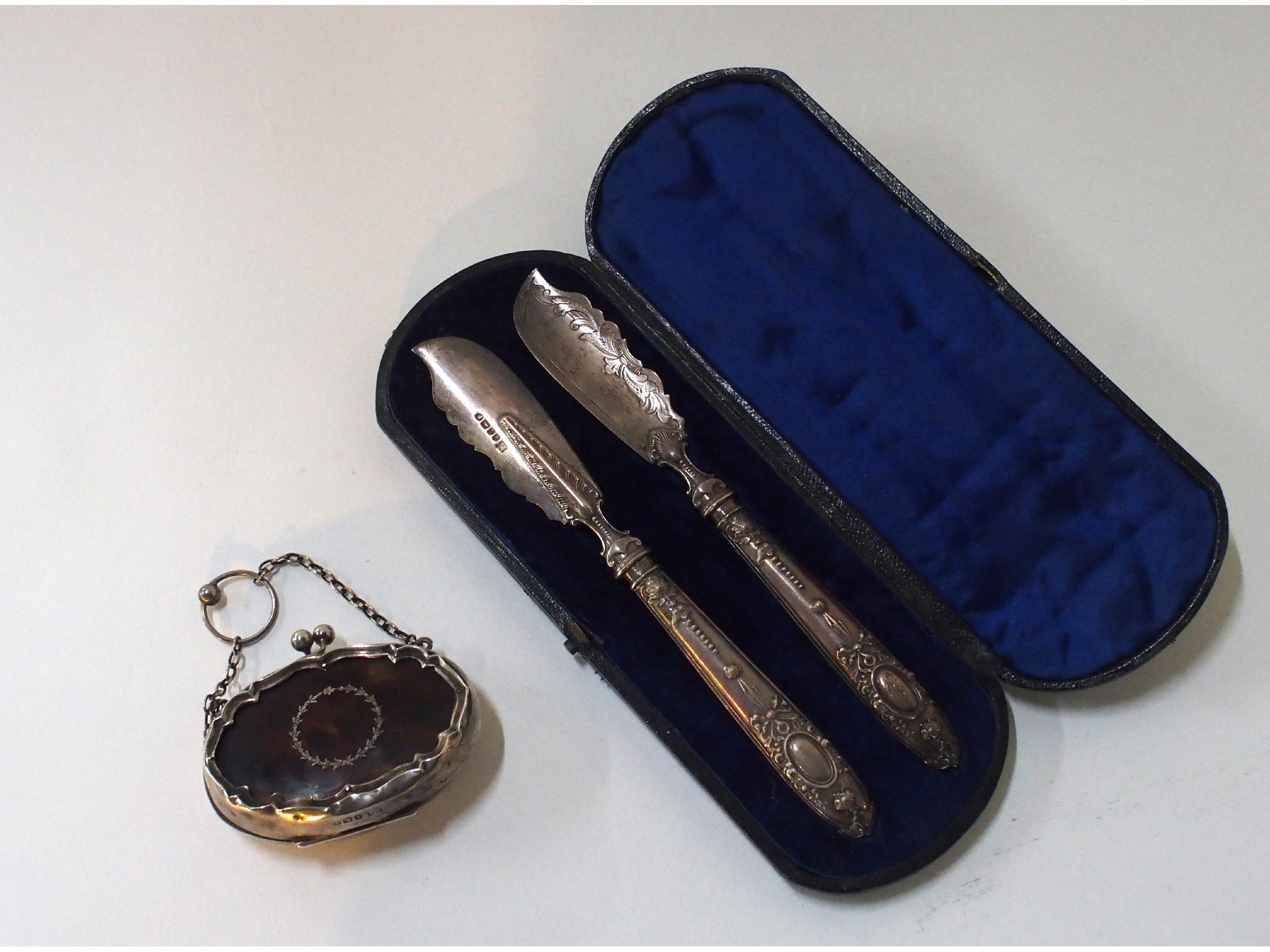 Appraisal: A lot comprising a cased pair of silver butter knives