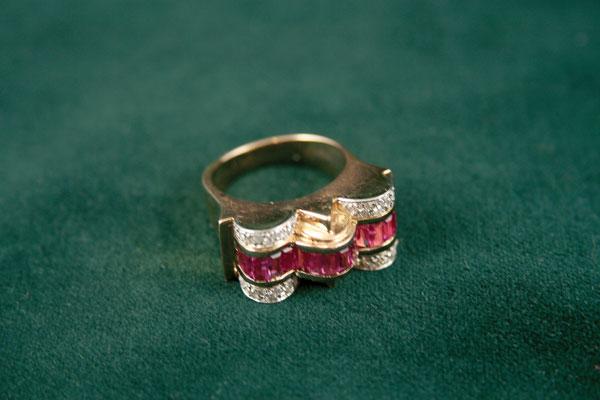 Appraisal: A Cocktail Ring Collet-set baguette-cut rubies between friezes of numerous