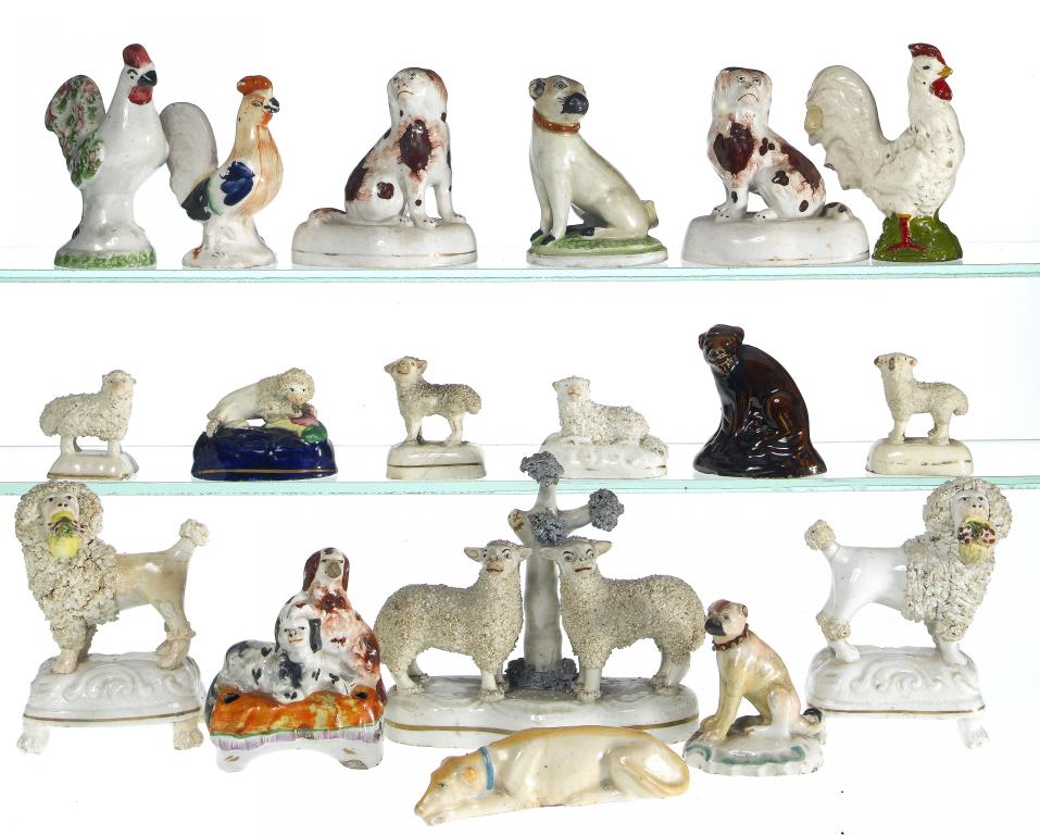 Appraisal: A COLLECTION OF STAFFORDSHIRE EARTHENWARE MINIATURE MODELS OF SPANIELS PUGS