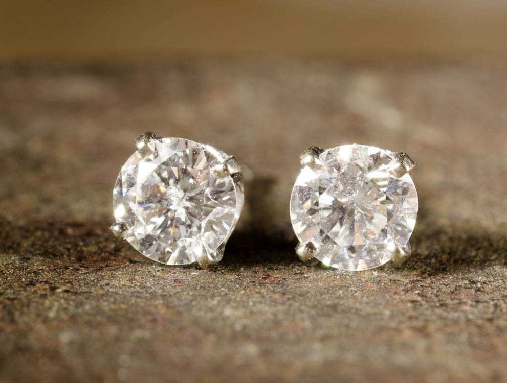 Appraisal: PAIR OF DIAMOND AND FOURTEEN KARAT GOLD EAR STUDS Each