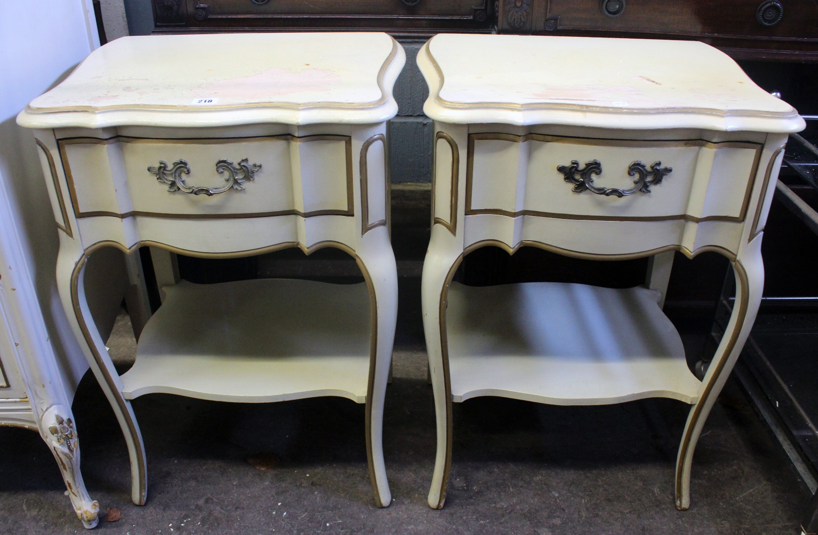 Appraisal: A pair of reproduction cream and gilt painted two tier