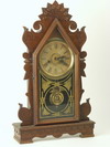 Appraisal: MANTEL CLOCK - th C walnut gingerbread style mantel clock