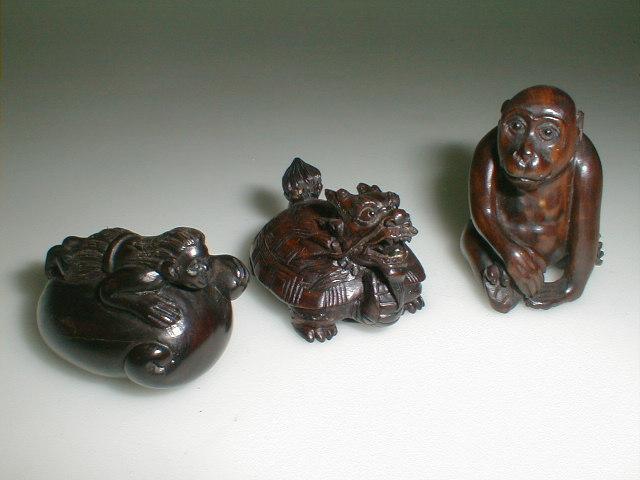 Appraisal: Three hardwood netsuke of a monkey a dragon turtle and