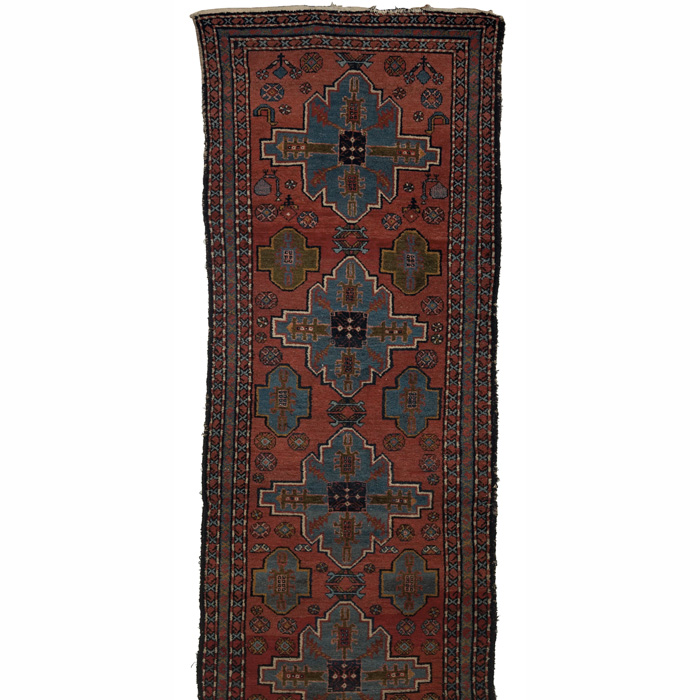 Appraisal: Kazak runner c floral pattern on a red field some