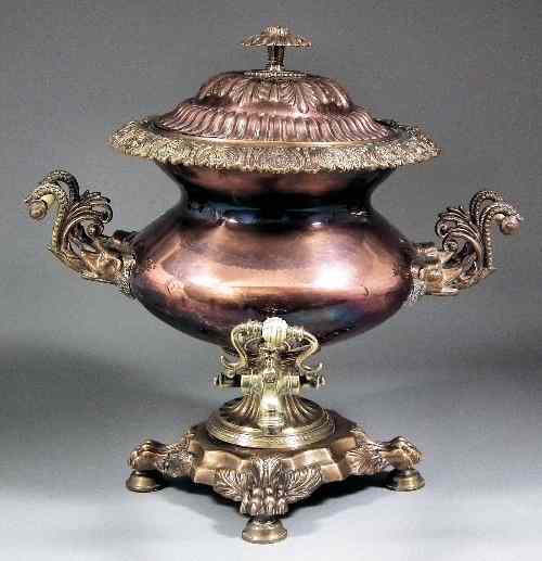 Appraisal: An early Victorian copper and brass two-handled tea urn of