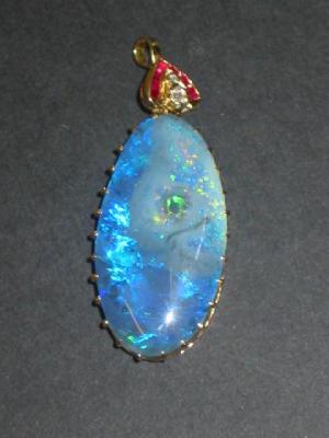 Appraisal: A BLACK OPAL PENDANT the large oval opal high claw