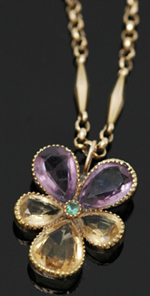 Appraisal: A citrine amethyst and emerald pendant The flower pendant suspended