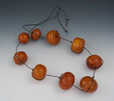 Appraisal: A String of Nine Large Amber Bead Necklace The beads