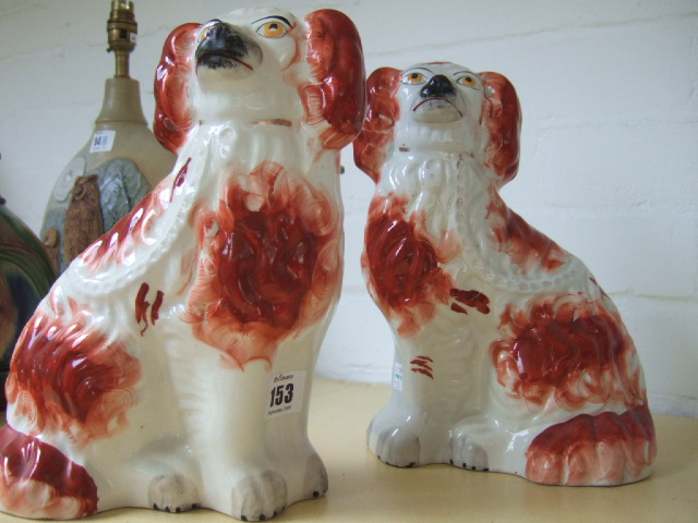 Appraisal: A pair of Staffordshire spaniels late th century with red