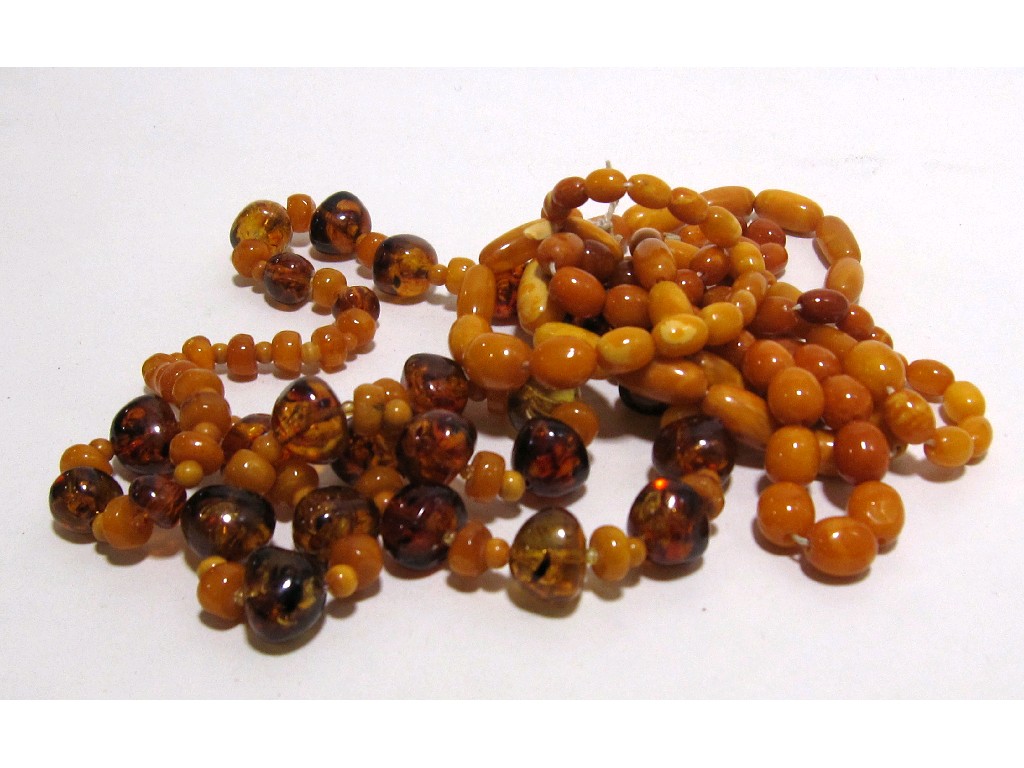 Appraisal: Three strings of yellow amber beads