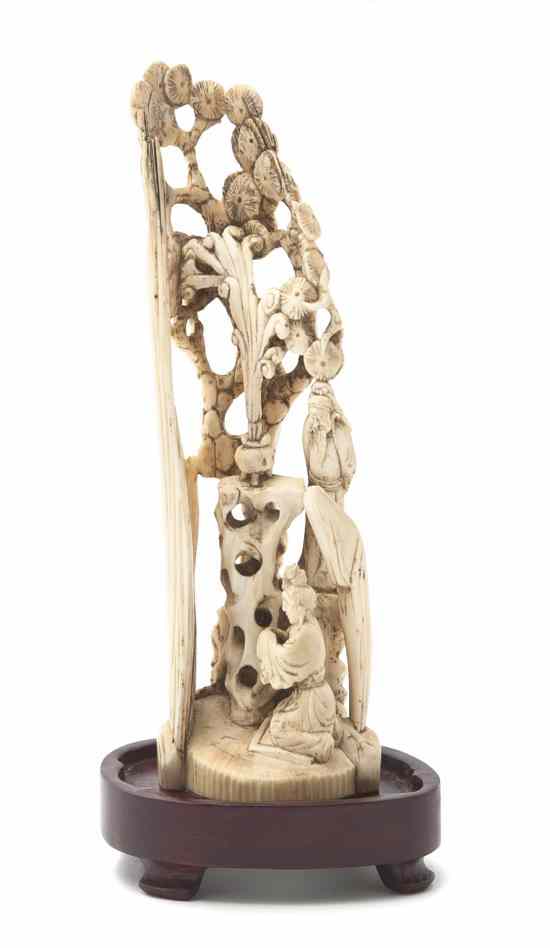 Appraisal: A Chinese Ivory Mountain depicting a kneeling figure before a