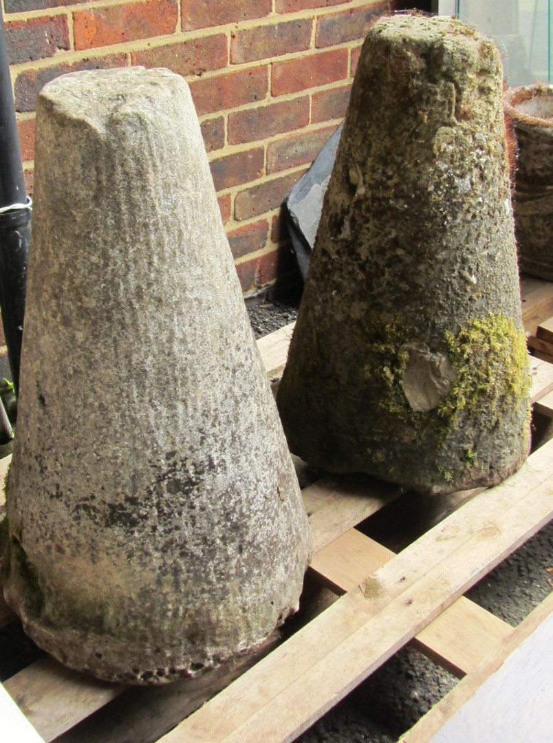 Appraisal: A pair of tapering conical carved saddle stone bases cm