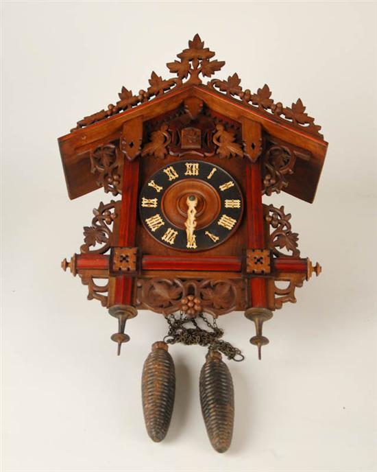 Appraisal: A Black Forest Cuckoo Clock of mixed woods having applied