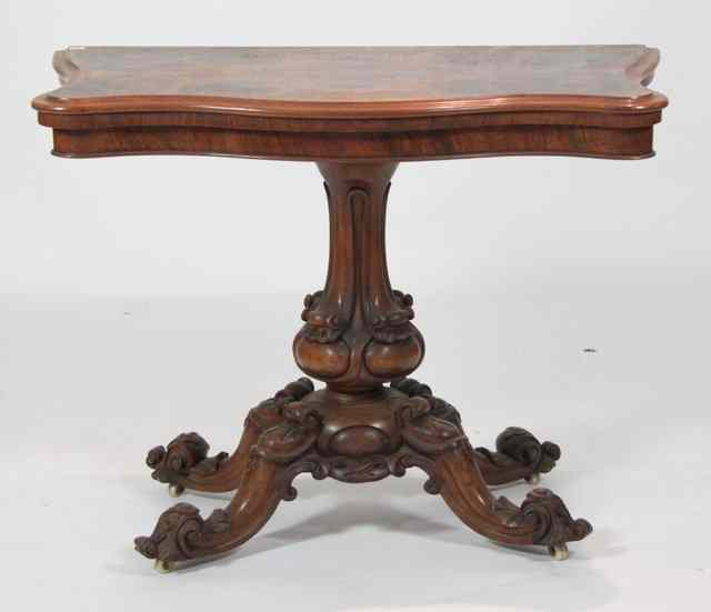 Appraisal: A Victorian walnut tea table the serpentine front fold-over top