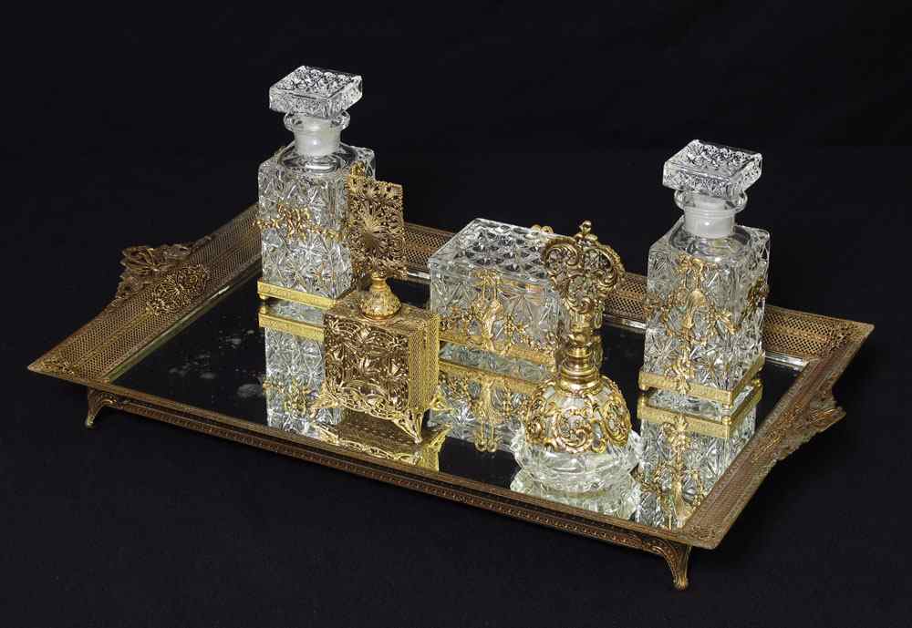 Appraisal: MIRRORED DRESSER TRAY AND BOTTLES Reticulated footed metal tray with